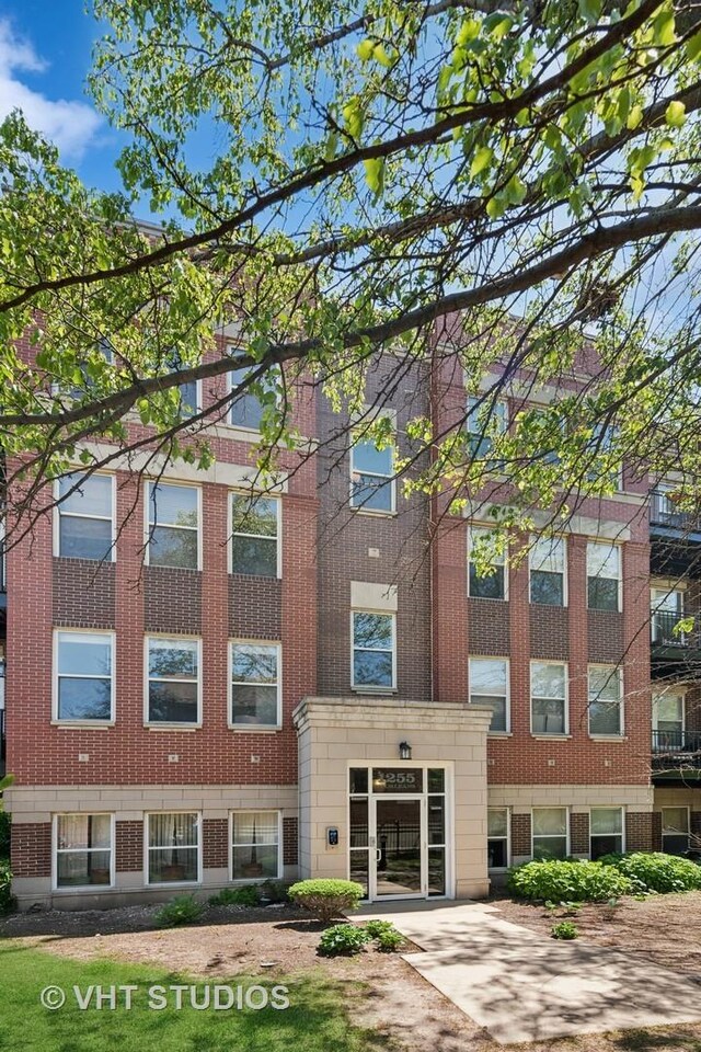 1255 N Orleans St Unit 1103, Chicago, IL 60610 - view of building exterior featuring concrete driveway