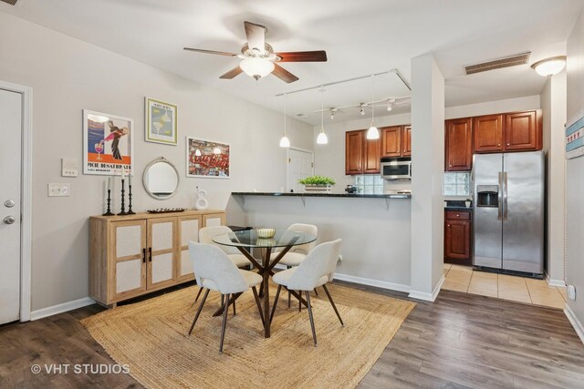 1255 N Orleans St Unit 1103, Chicago, IL 60610 - dining space featuring rail lighting, a ceiling fan, and light wood-style floors