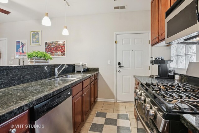 1255 N Orleans St Unit 1103, Chicago, IL 60610 - kitchen featuring stainless steel appliances, light tile patterned flooring, decorative light fixtures, dark stone countertops, and a ceiling fan