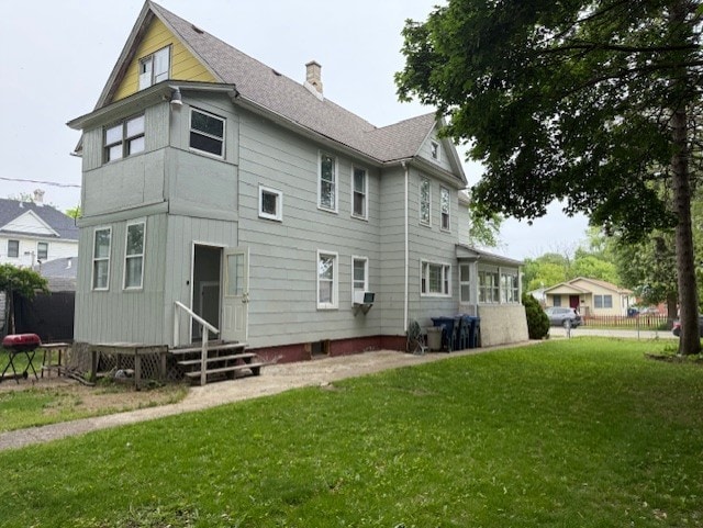 670 S Martin Luther King Jr Ave, Waukegan, IL 60085 - rear view of house featuring entry steps and a chimney