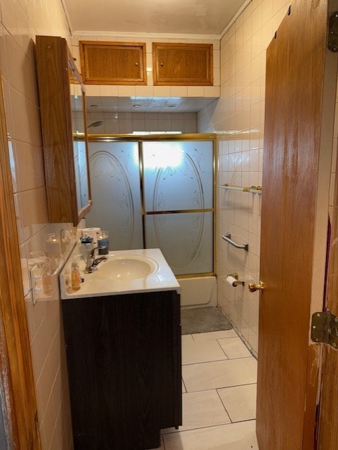 670 S Martin Luther King Jr Ave, Waukegan, IL 60085 - full bath featuring vanity, tub / shower combination, tile walls, and tile patterned floors