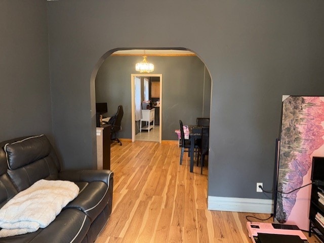 670 S Martin Luther King Jr Ave, Waukegan, IL 60085 - living area with arched walkways, light wood-type flooring, and a chandelier