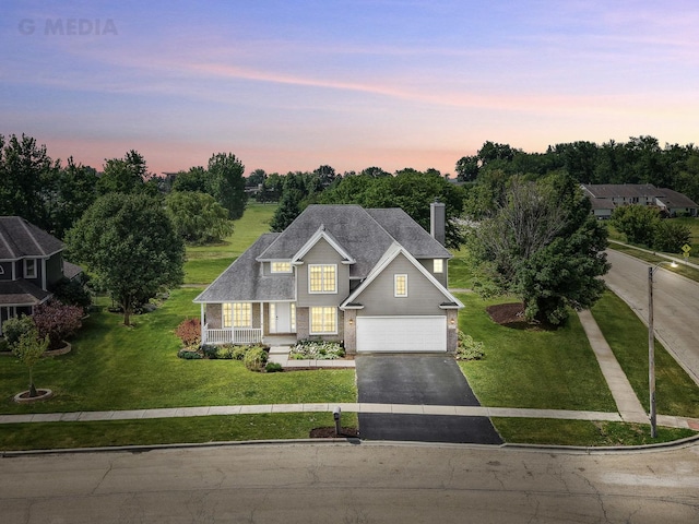 200 Saint Andrews Dr, Dekalb, IL 60115 - traditional-style home featuring driveway, a chimney, a porch, and a front yard
