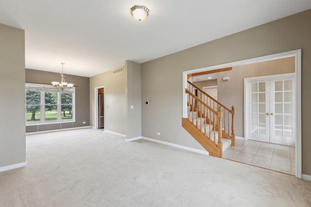 200 Saint Andrews Dr, Dekalb, IL 60115 - carpeted empty room featuring french doors, a chandelier, and stairs