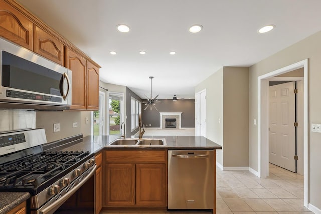 200 Saint Andrews Dr, Dekalb, IL 60115 - kitchen featuring stainless steel appliances, dark countertops, a peninsula, recessed lighting, and brown cabinetry