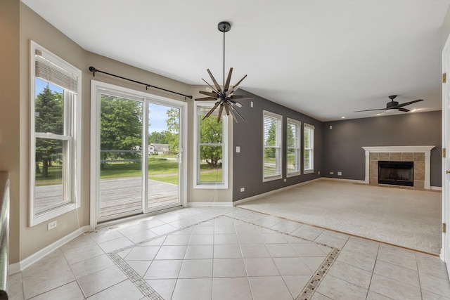 200 Saint Andrews Dr, Dekalb, IL 60115 - unfurnished living room featuring ceiling fan, a tiled fireplace, light tile patterned floors, and inlaid floor details