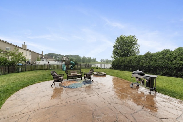 741 Oakwood St, Minooka, IL 60447 - fenced backyard with an outdoor fire pit, a patio area, a playground, and a water view