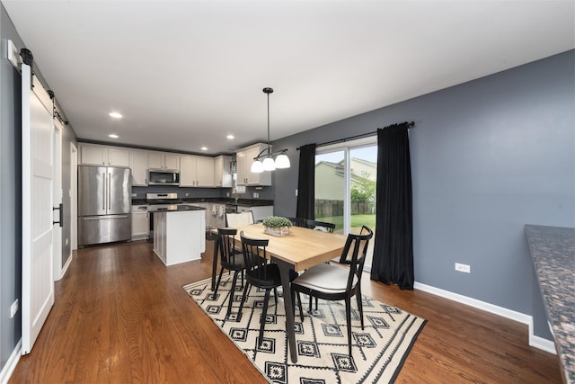 741 Oakwood St, Minooka, IL 60447 - dining space featuring dark wood-style flooring, recessed lighting, and a barn door