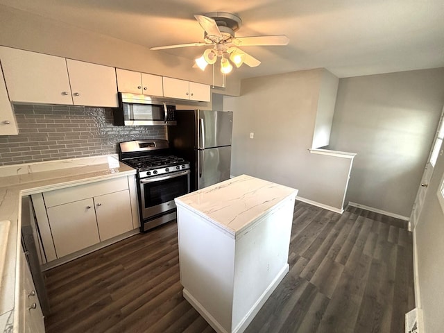 126 N Prairie Ave, Bloomingdale, IL 60108 - kitchen featuring appliances with stainless steel finishes, ceiling fan, decorative backsplash, dark wood-style flooring, and white cabinets