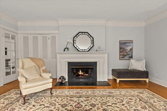 633 Forest Ave, Wilmette, IL 60091 - sitting room with wood finished floors, crown molding, and a warm lit fireplace