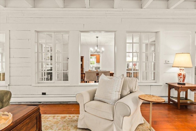 633 Forest Ave, Wilmette, IL 60091 - living room with wood finished floors, a chandelier, and baseboard heating