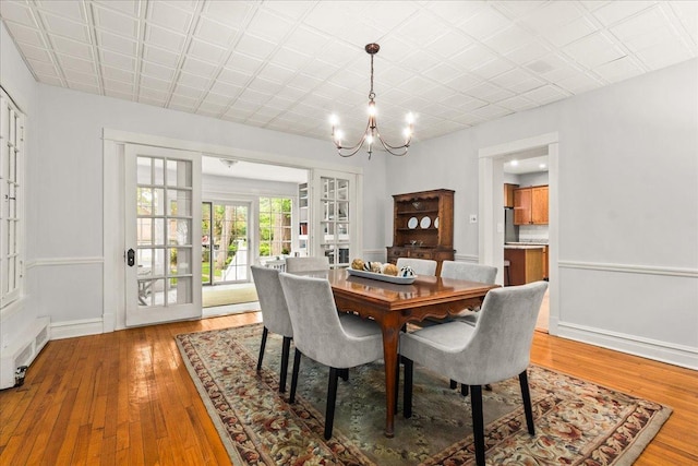 633 Forest Ave, Wilmette, IL 60091 - dining space with a chandelier, light wood-style floors, and french doors