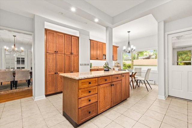 633 Forest Ave, Wilmette, IL 60091 - kitchen featuring a chandelier, brown cabinetry, light tile patterned floors, a center island, and recessed lighting