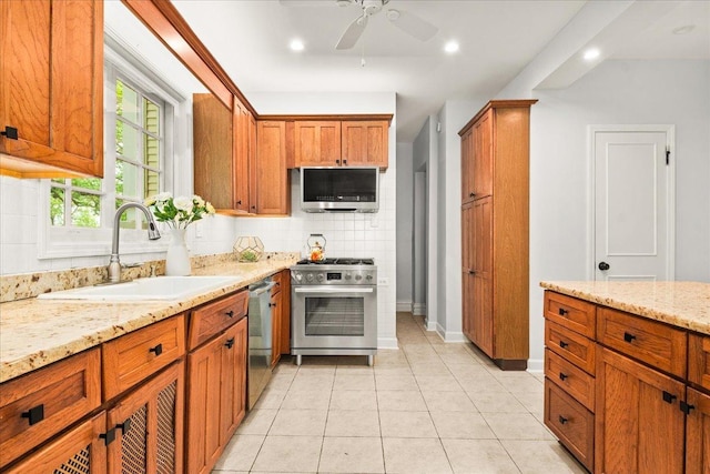 633 Forest Ave, Wilmette, IL 60091 - kitchen featuring stainless steel appliances, ceiling fan, tasteful backsplash, brown cabinets, and light stone counters