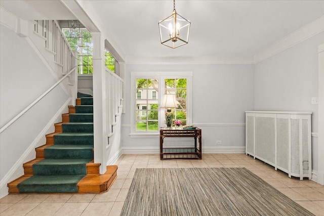 633 Forest Ave, Wilmette, IL 60091 - tiled entryway with stairway, a chandelier, and crown molding