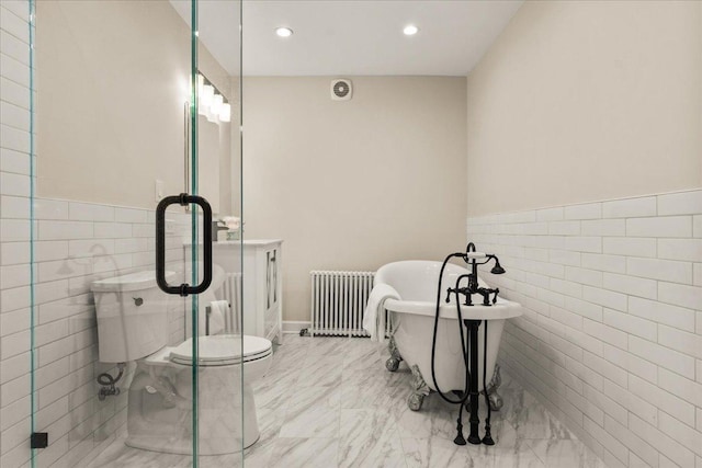 633 Forest Ave, Wilmette, IL 60091 - full bathroom with radiator heating unit, tile walls, marble finish flooring, a freestanding bath, and wainscoting