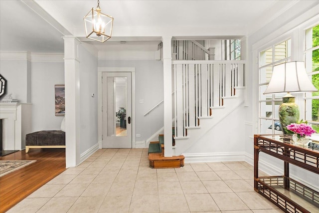 633 Forest Ave, Wilmette, IL 60091 - foyer featuring plenty of natural light, stairs, ornamental molding, a chandelier, and tile patterned floors