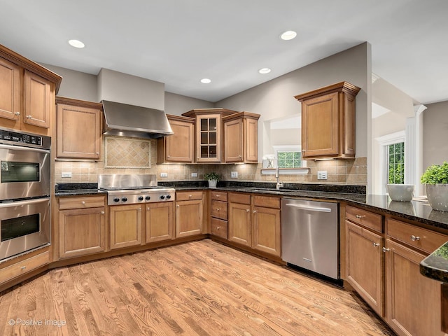 508 Gene Darfler Ct, Naperville, IL 60565 - kitchen with stainless steel appliances, wall chimney exhaust hood, brown cabinetry, plenty of natural light, and recessed lighting