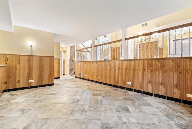 1018 Bob O Link Ln, Darien, IL 60561 - spare room with wood walls, a wainscoted wall, stone finish floors, and stairway
