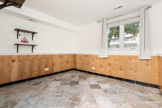 1018 Bob O Link Ln, Darien, IL 60561 - unfurnished room with stone finish flooring, wainscoting, and wooden walls
