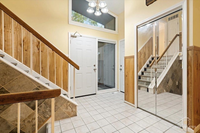 1018 Bob O Link Ln, Darien, IL 60561 - entryway with stairs, a chandelier, wainscoting, and light tile patterned floors