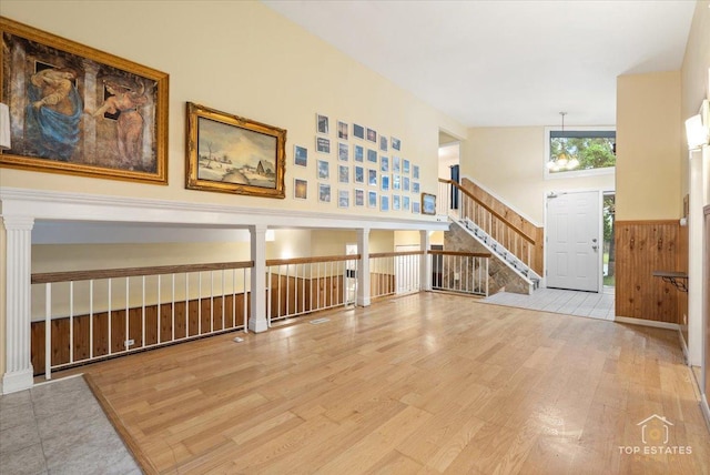 1018 Bob O Link Ln, Darien, IL 60561 - unfurnished room with wood finished floors, wainscoting, and stairway
