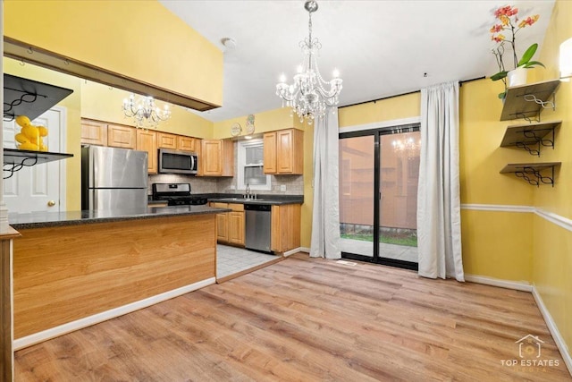 1018 Bob O Link Ln, Darien, IL 60561 - kitchen featuring appliances with stainless steel finishes, a chandelier, dark countertops, and light wood-type flooring