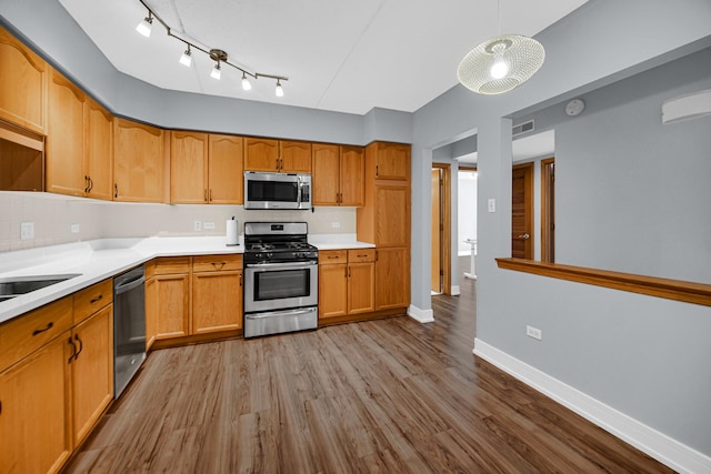 1636 Ashland Ave Unit 209, Des Plaines, IL 60016 - kitchen featuring stainless steel appliances, wood finished floors, light countertops, tasteful backsplash, and pendant lighting