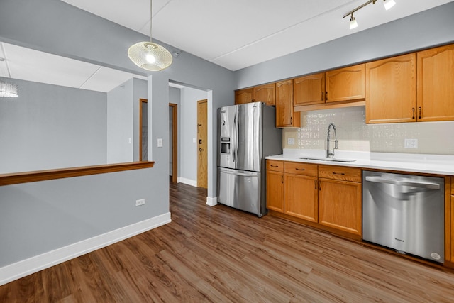 1636 Ashland Ave Unit 209, Des Plaines, IL 60016 - kitchen featuring appliances with stainless steel finishes, wood finished floors, light countertops, decorative backsplash, and hanging light fixtures