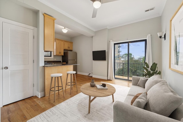 1709 N Paulina St Unit 303, Chicago, IL 60622 - living area featuring light wood finished floors, a ceiling fan, and ornamental molding