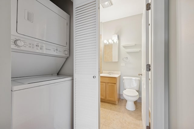1709 N Paulina St Unit 303, Chicago, IL 60622 - laundry room featuring stacked washer / dryer and light tile patterned floors