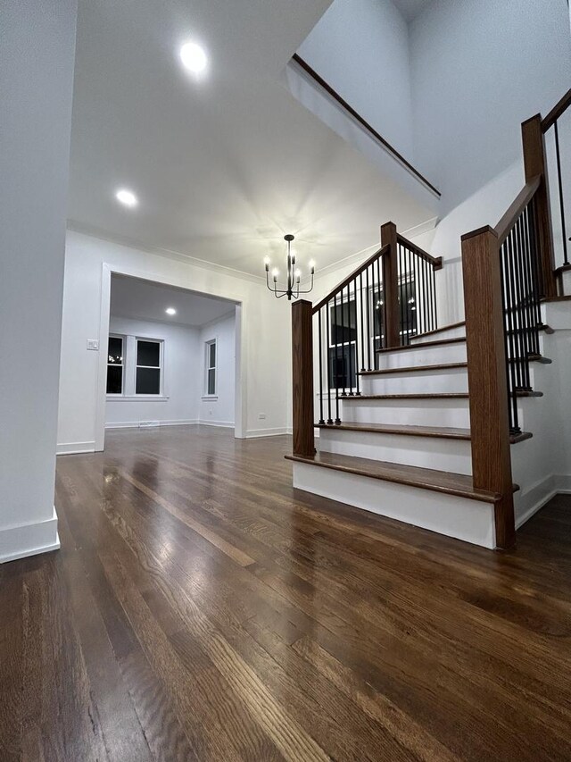 4843 W Schubert Ave, Chicago, IL 60639 - stairway featuring a chandelier, wood finished floors, and recessed lighting