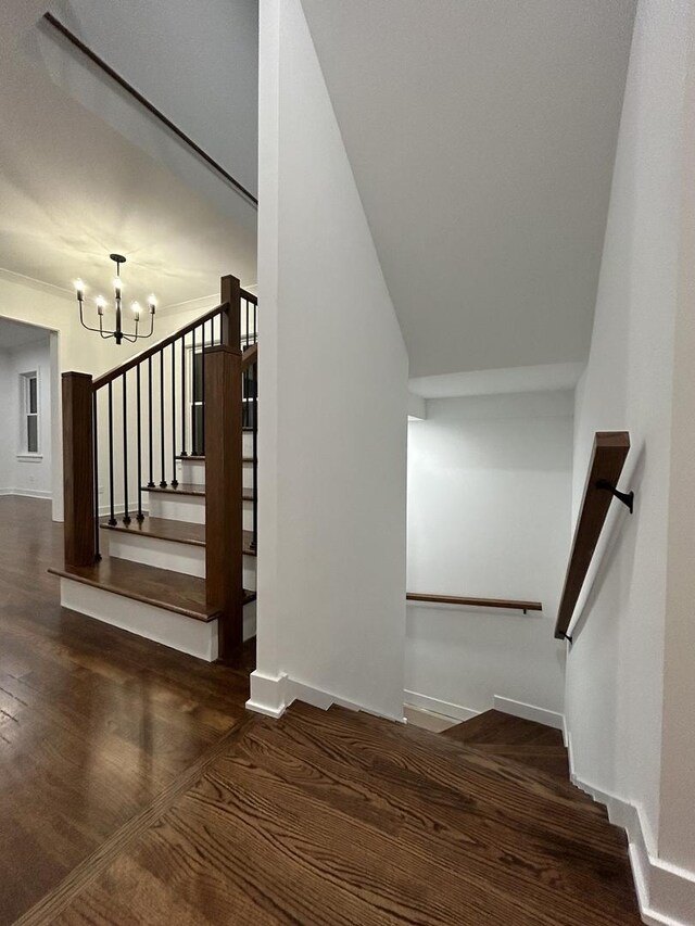 4843 W Schubert Ave, Chicago, IL 60639 - staircase featuring a chandelier and wood finished floors