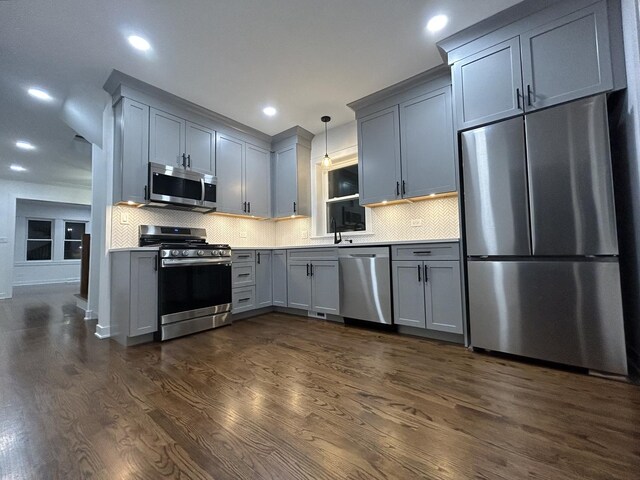 4843 W Schubert Ave, Chicago, IL 60639 - kitchen with stainless steel appliances, gray cabinets, dark wood finished floors, tasteful backsplash, and recessed lighting
