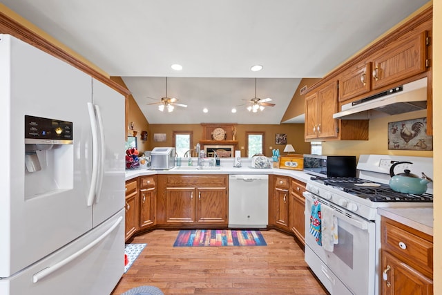 107 Sibley Dr, Minooka, IL 60447 - kitchen with white appliances, under cabinet range hood, ceiling fan, light wood-style flooring, and vaulted ceiling