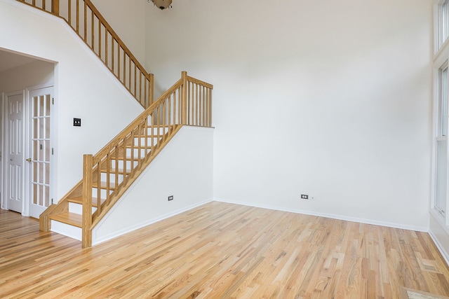 902 Heathrow Ln, Naperville, IL 60540 - unfurnished living room with stairway, wood finished floors, and a high ceiling