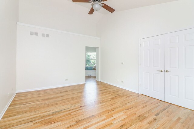 902 Heathrow Ln, Naperville, IL 60540 - unfurnished bedroom featuring high vaulted ceiling, light wood-style floors, ceiling fan, and a closet