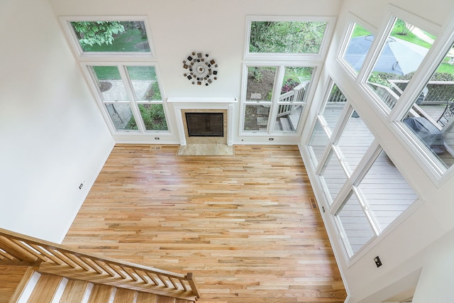 902 Heathrow Ln, Naperville, IL 60540 - unfurnished living room with a towering ceiling, light wood-style floors, and a fireplace