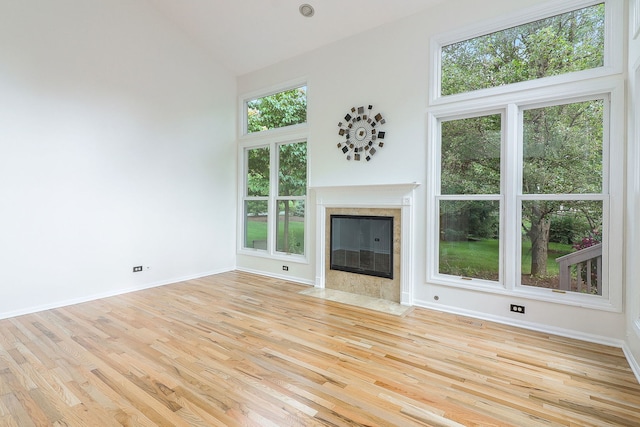 902 Heathrow Ln, Naperville, IL 60540 - unfurnished living room featuring high vaulted ceiling, light wood-style flooring, plenty of natural light, and a fireplace