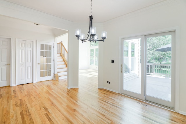902 Heathrow Ln, Naperville, IL 60540 - unfurnished dining area with a chandelier, light wood finished floors, plenty of natural light, and crown molding