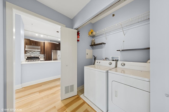 8 E Randolph St Unit 3203, Chicago, IL 60601 - washroom with washer and clothes dryer, light wood-type flooring, and track lighting