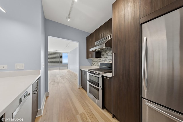 8 E Randolph St Unit 3203, Chicago, IL 60601 - kitchen featuring appliances with stainless steel finishes, ventilation hood, track lighting, light wood-style floors, and light countertops