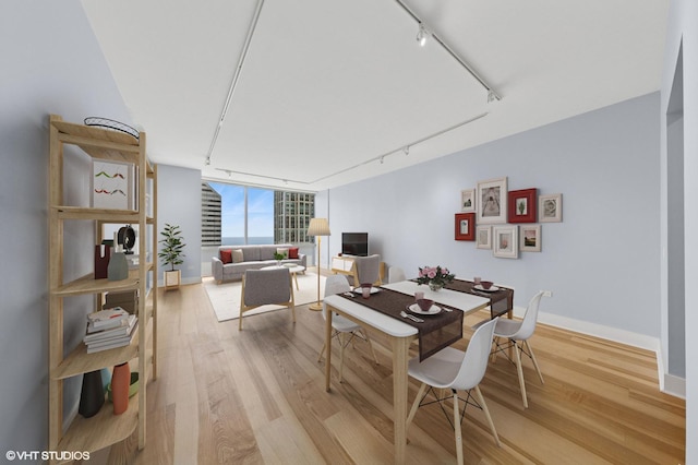 8 E Randolph St Unit 3203, Chicago, IL 60601 - dining space with rail lighting, light wood-style floors, and a wall of windows