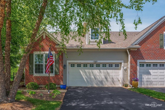 1568 Sedona Ave, Aurora, IL 60504 - view of front facade featuring asphalt driveway, brick siding, and a shingled roof