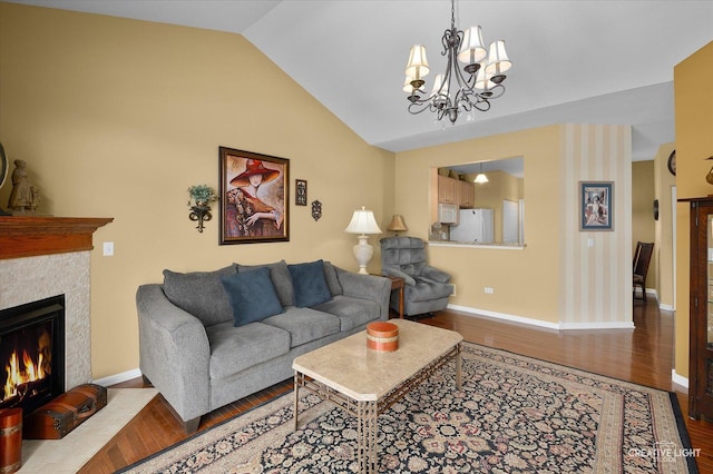 1568 Sedona Ave, Aurora, IL 60504 - living room with wood finished floors, lofted ceiling, a chandelier, and a lit fireplace