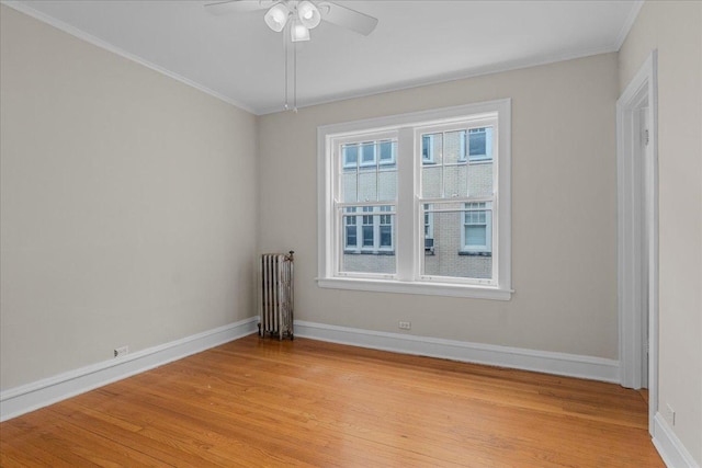 819 Forest Ave Unit 2W, Evanston, IL 60202 - unfurnished room featuring light wood-style floors, crown molding, ceiling fan, and radiator heating unit