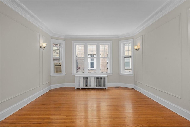 819 Forest Ave Unit 2W, Evanston, IL 60202 - spare room with radiator, wood finished floors, crown molding, and cooling unit