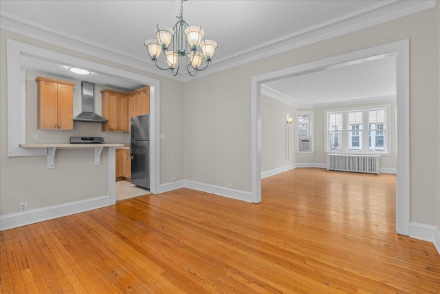 819 Forest Ave Unit 2W, Evanston, IL 60202 - kitchen featuring radiator, wall chimney range hood, freestanding refrigerator, light wood-type flooring, and a breakfast bar area