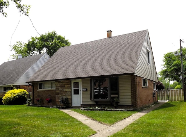 17008 Oakwood Ave, Lansing, IL 60438 - view of front of house featuring brick siding, roof with shingles, and a chimney