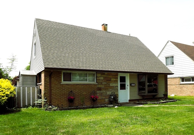 17008 Oakwood Ave, Lansing, IL 60438 - back of property with a chimney, a shingled roof, and brick siding